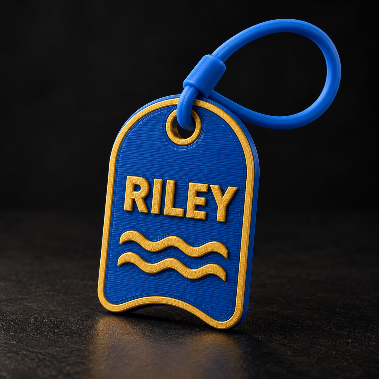 Blue and gold personalized bag tag reading Riley